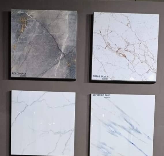 Glossy marble-effect floor tiles on display — construction materials supplied to Bhutan